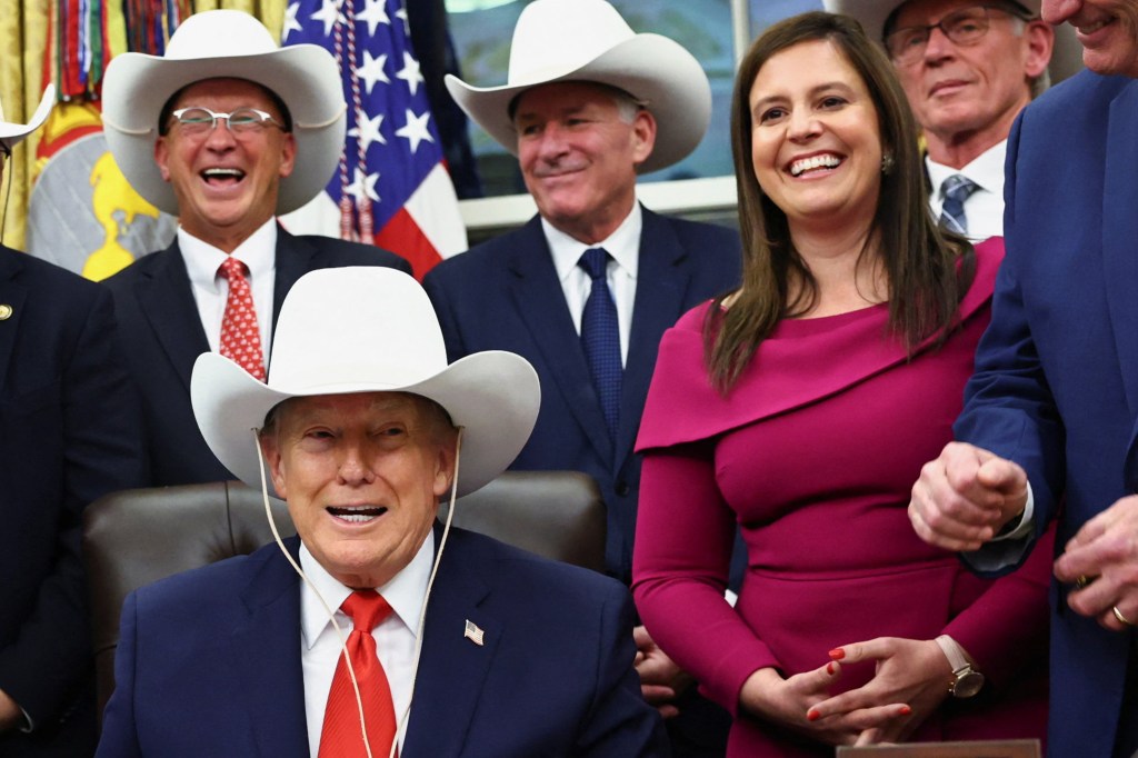 U.S. President Donald Trump and attendees wearing cowboy hats react while signing a bill to award congressional gold medals to the 1980 U.S. Olympic men's hockey team.