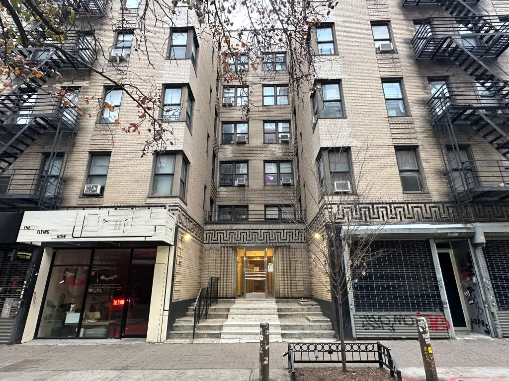 20 Clinton Street apartment building with fire escapes and a storefront for