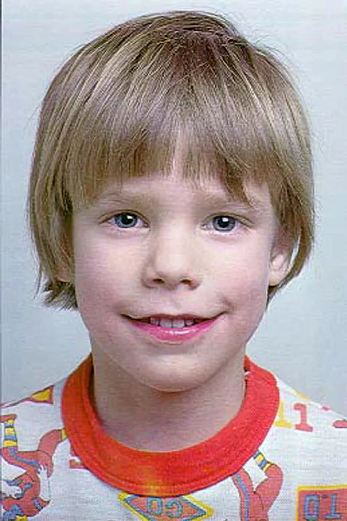 Close-up of Etan Patz smiling, wearing a colorful T-shirt.
