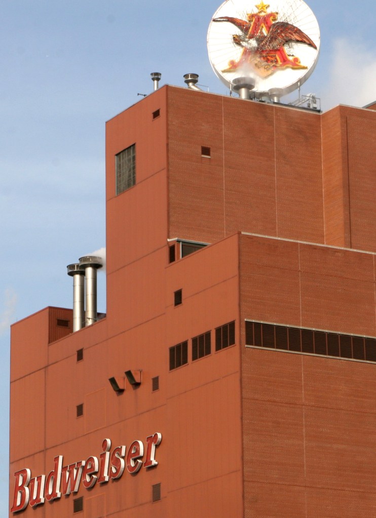 Budweiser sign and logo on the side of the Anheuser-Busch brewing facility.