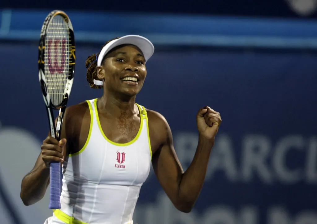 Venus Williams of the US celebrates her victory over France's Virginie Razzano in the WTA Dubai Tennis Championships final in the Gulf emirate on February 21, 2009. Williams returned to the world's top five for the first time in six years by clinching the 40th title of her career with a 6-4, 6-2 win over Razzano. AFP PHOTO/KARIM SAHIB (Photo by KARIM SAHIB / AFP) (Photo by KARIM SAHIB/AFP via Getty Images)
