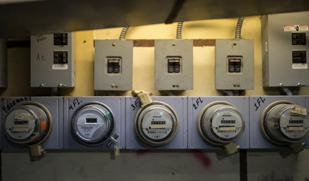 Five Con Edison electricity meters measure power consumption in a Brooklyn apartment building.