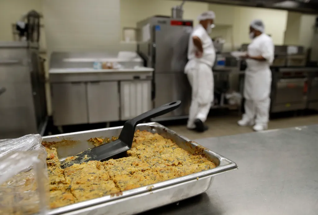 A pan of nutraloaf with a spatula in a kitchen.