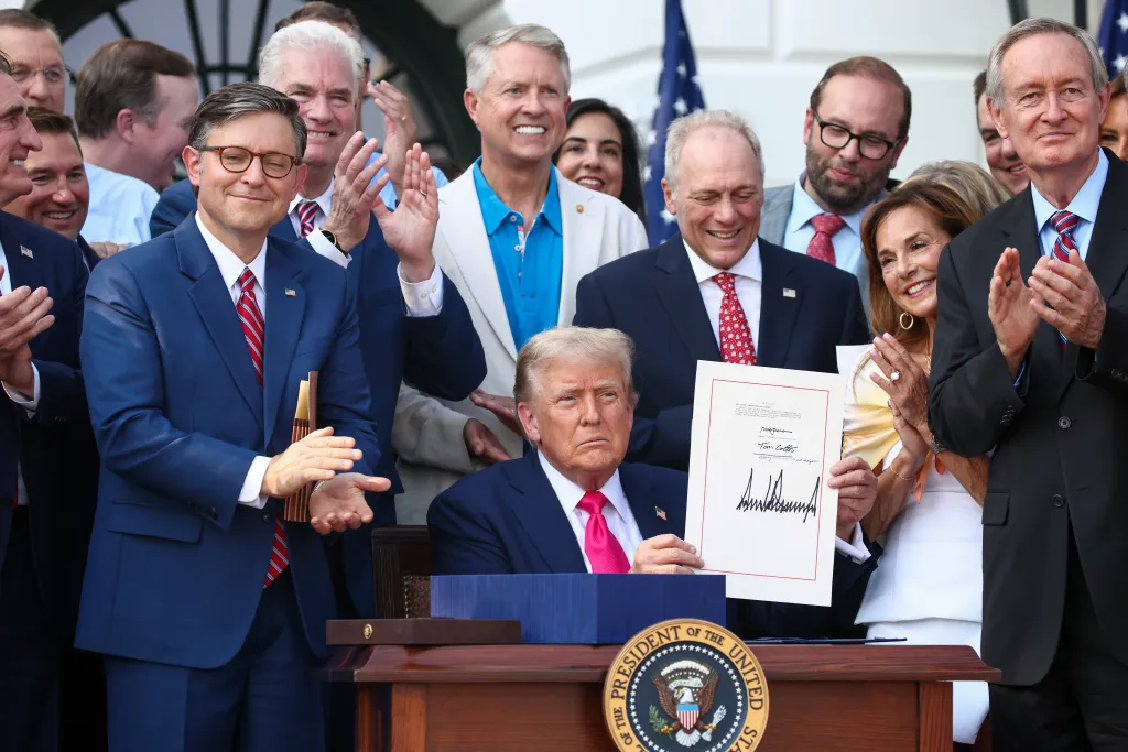 President Donald Trump signs the One, Big Beautiful Bill Act during a signing ceremony on the South Lawn of the White House on July 4, 2025.