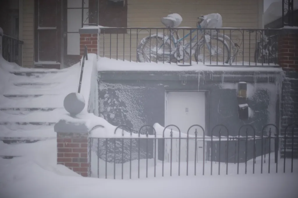 Snow covers bicycles and stairs of a residence in Atlantic City, New Jersey.
