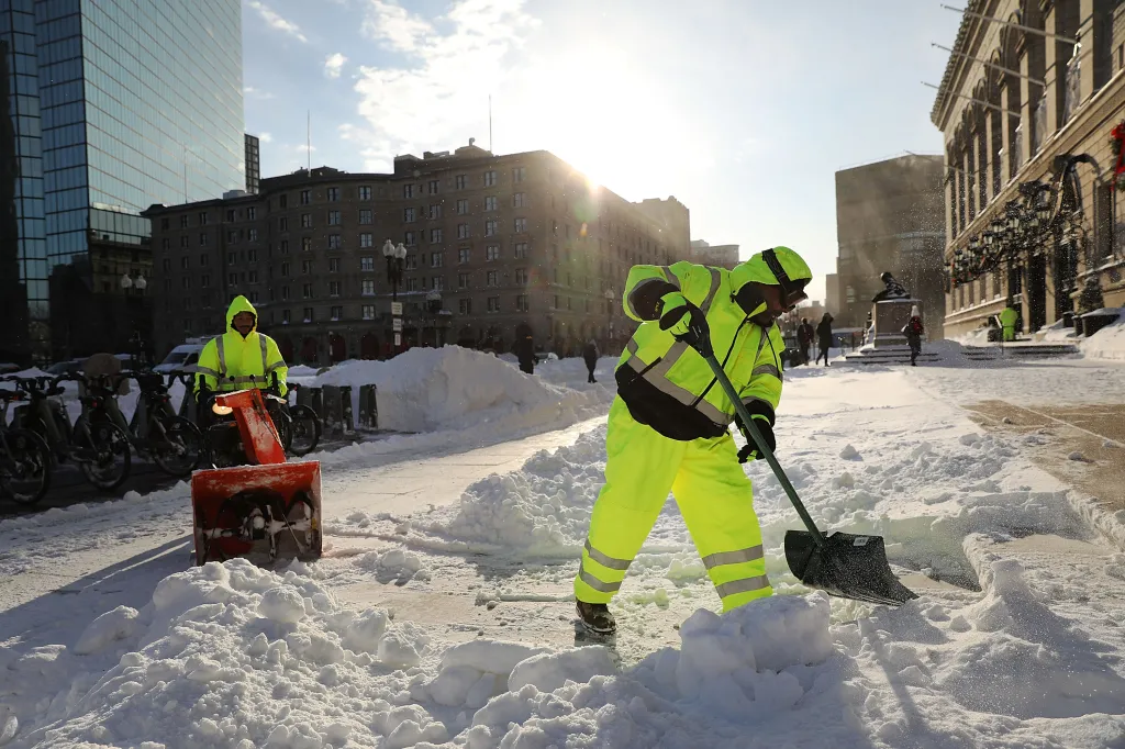 City workers clear snow after a winter storm in Boston.