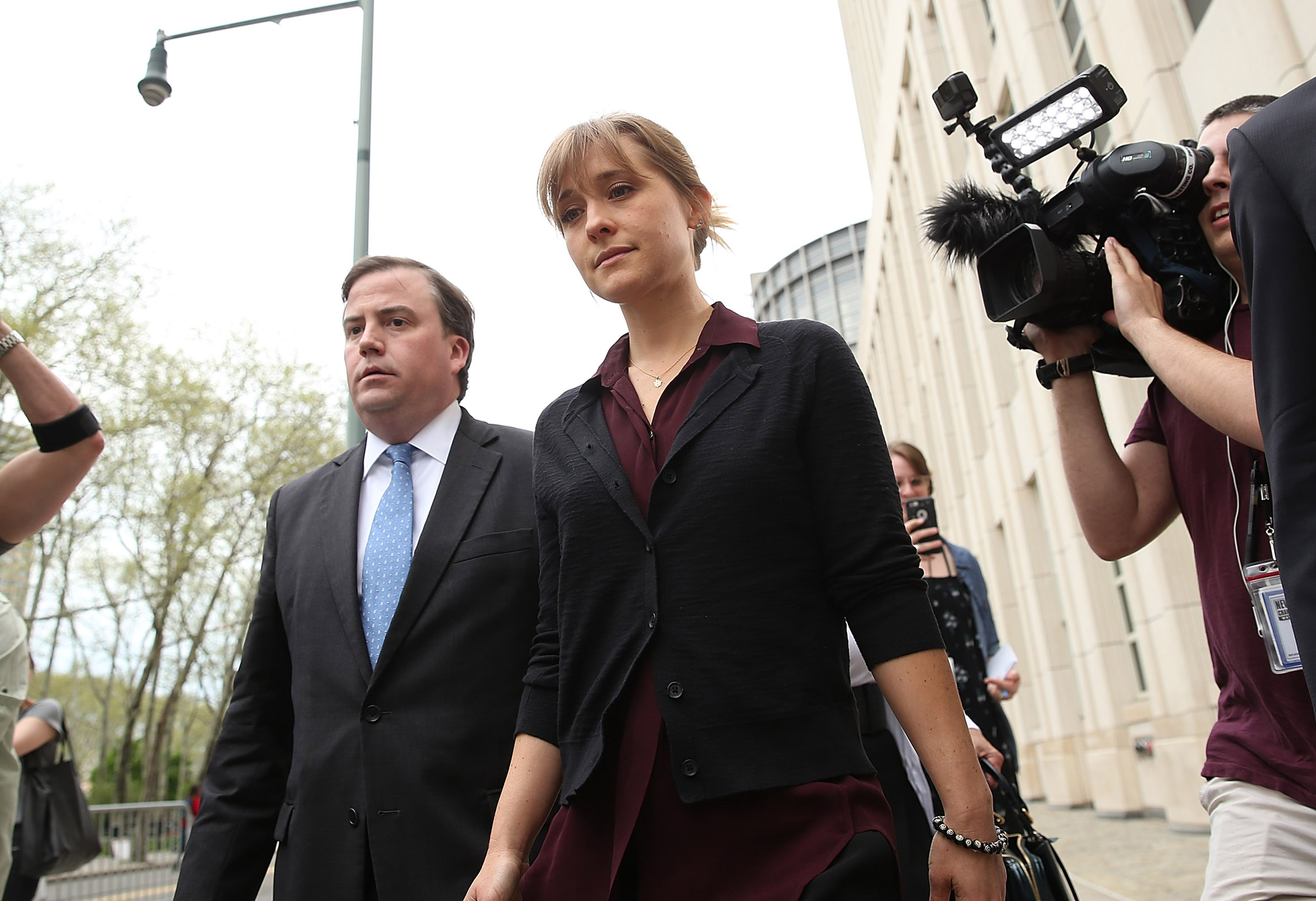 Allison Mack (C) departs the United States Eastern District Court after a bail hearing in relation to the sex trafficking charges filed against her on May 4, 2018 in the Brooklyn borough of New York City.