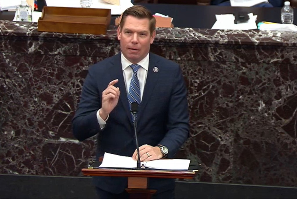 Impeachment Manager Rep. Eric Swalwell speaking at a podium during the second impeachment trial of Donald Trump.