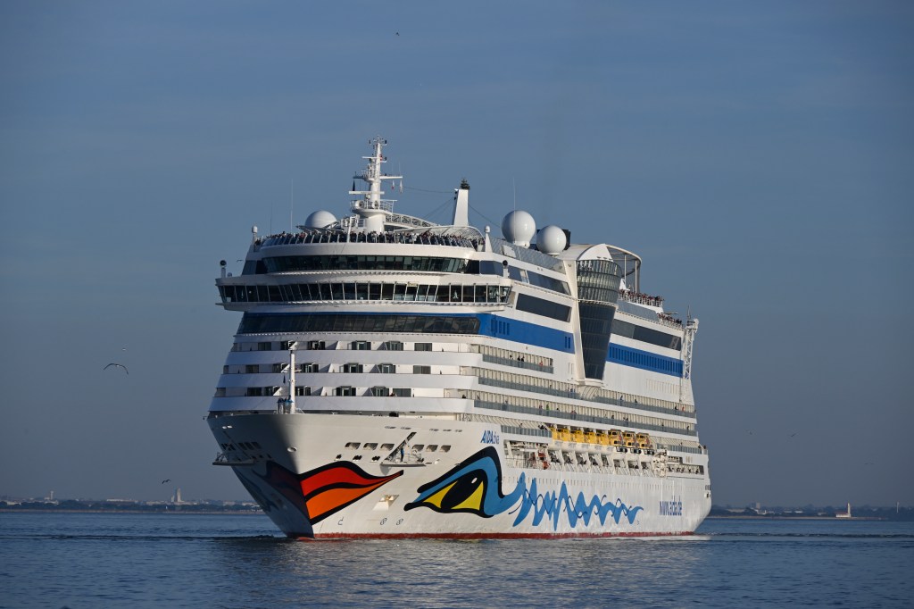 The AIDAdiva cruise ship sails on the Tagus River after leaving the Lisbon cruise terminal.