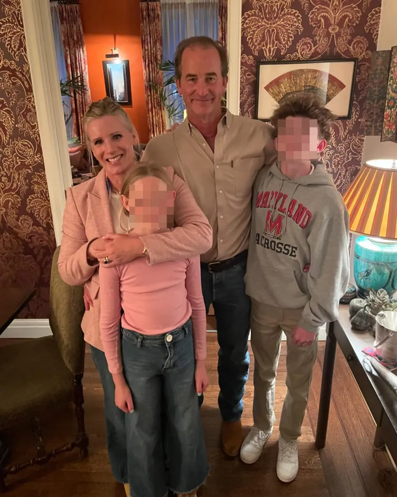 Kristin Cabot embracing Andrew Cabot with two children.