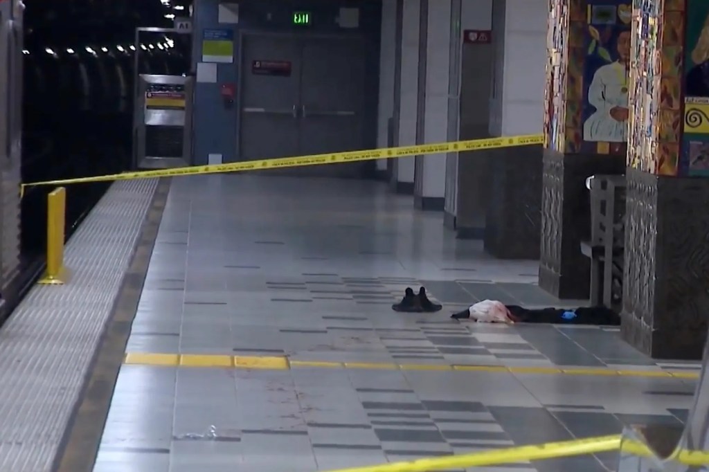 Crime scene at a metro station with yellow tape, shoes, and clothing on the ground.
