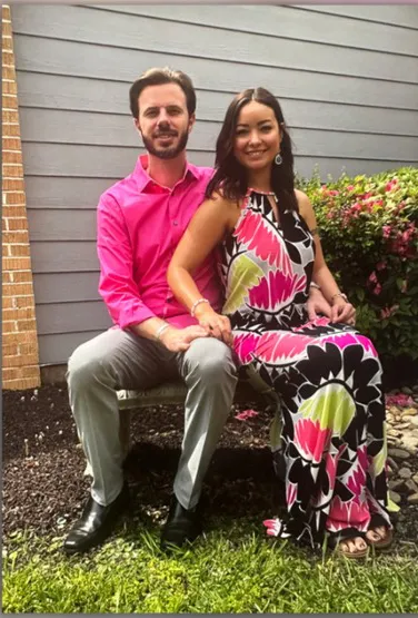 Mica Miller and her pastor husband sitting together on a bench.