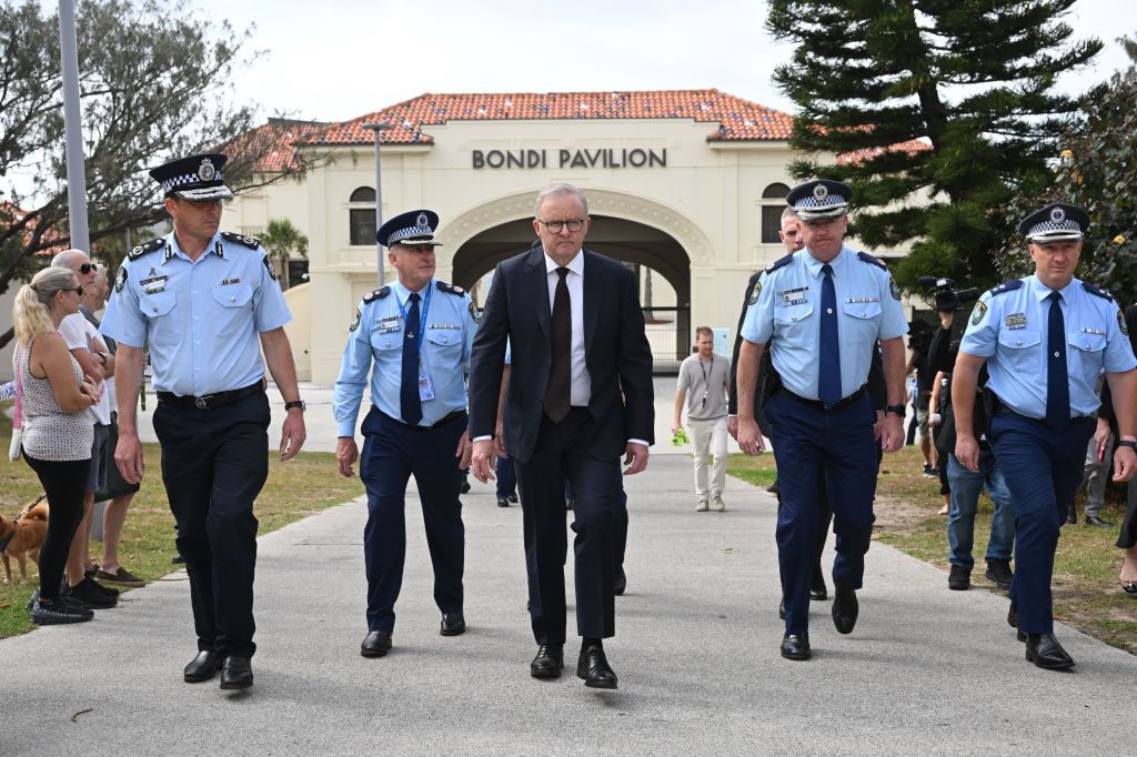 Australian Prime Minister Anthony Albanese walks with police officers outside Bondi Pavilion.