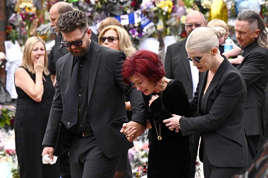 Jack Osbourne, Sharon Osbourne, and Kelly Osbourne arrive to view tributes to the late Ozzy Osbourne from fans as his funeral cortege travels through his home city of Birmingham.