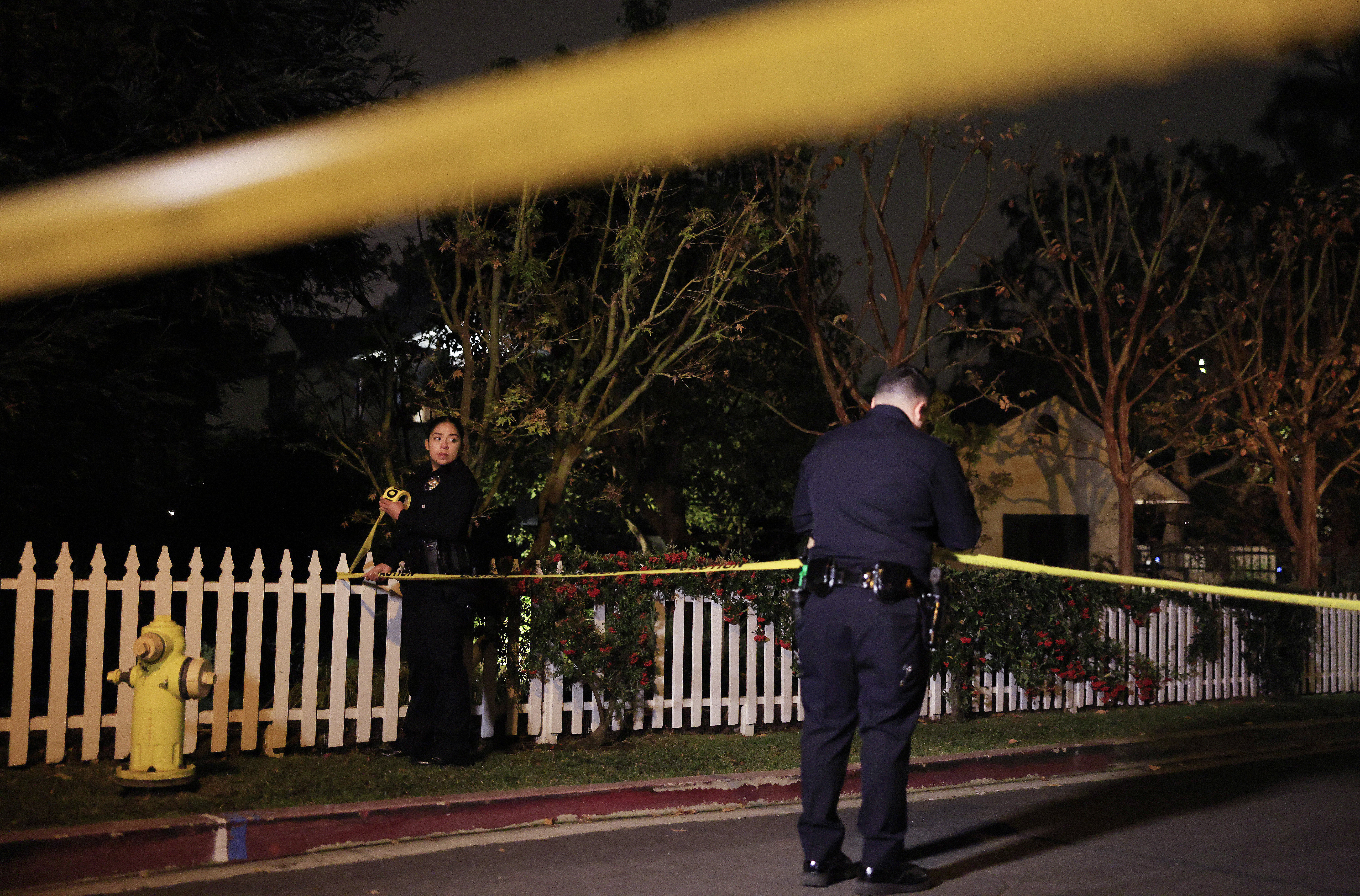 Police tape marks off an investigation scene outside Rob Reiner's Brentwood home.