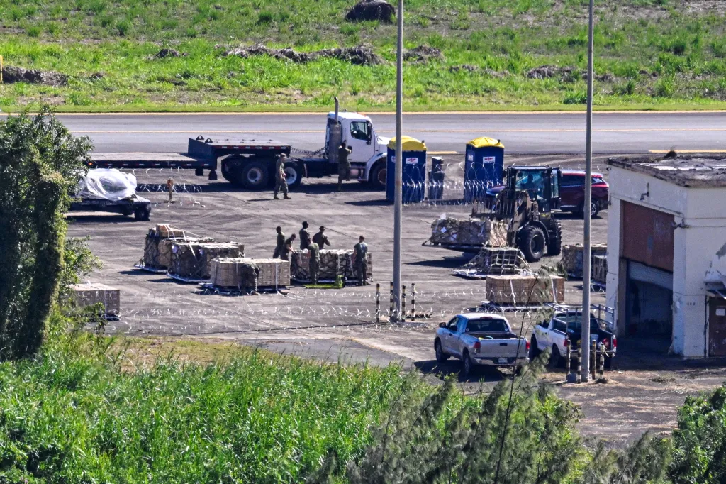 Military personnel loading equipment onto a truck and forklift at José Aponte de la Torre Airport in Ceiba, Puerto Rico.