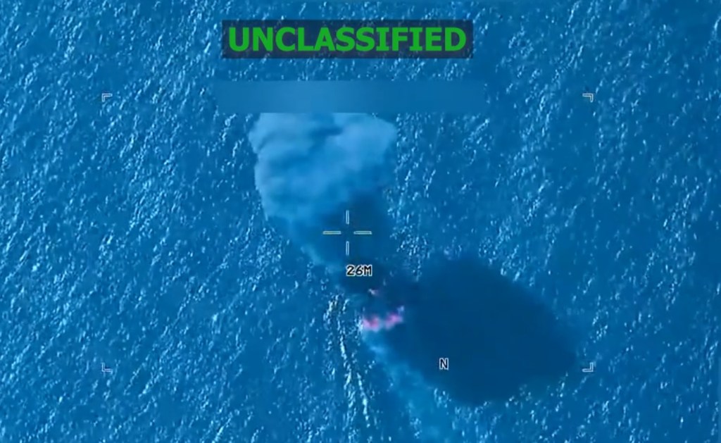 A vessel on fire in the ocean with