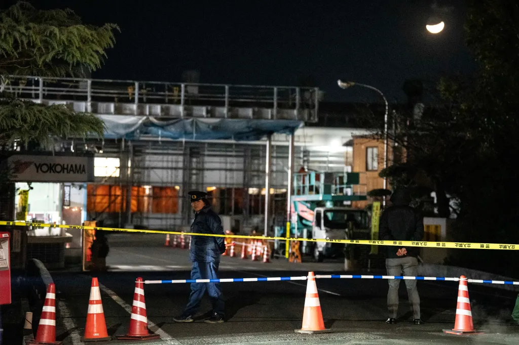 Police officer standing guard inside a cordon at the Yokohama Rubber Mishima Plant in Mishima, Japan.