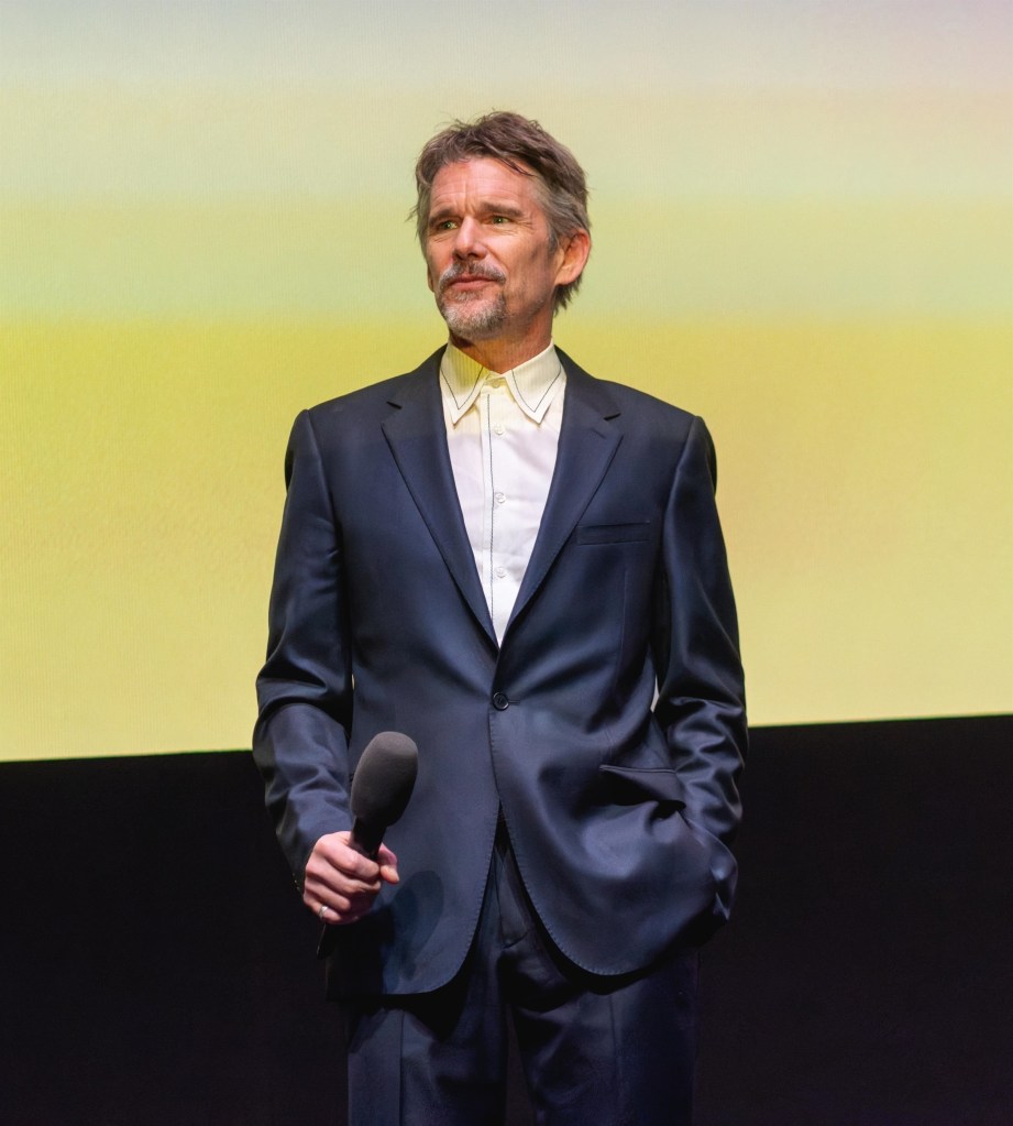 Ethan Hawke holding a microphone at the Blue Moon premiere at BFI London Film Festival 2025.