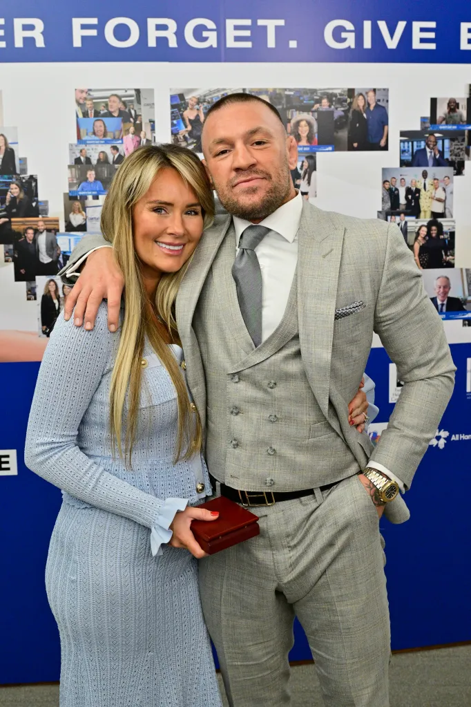 Dee Devlin and Conor McGregor posing together at the Charity Day 2025 event.