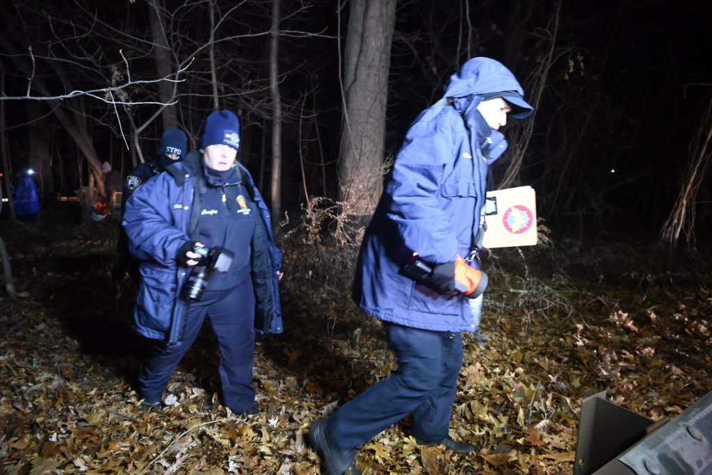 NYPD police and OCME personnel investigate human remains on the Major Deegan Expressway.