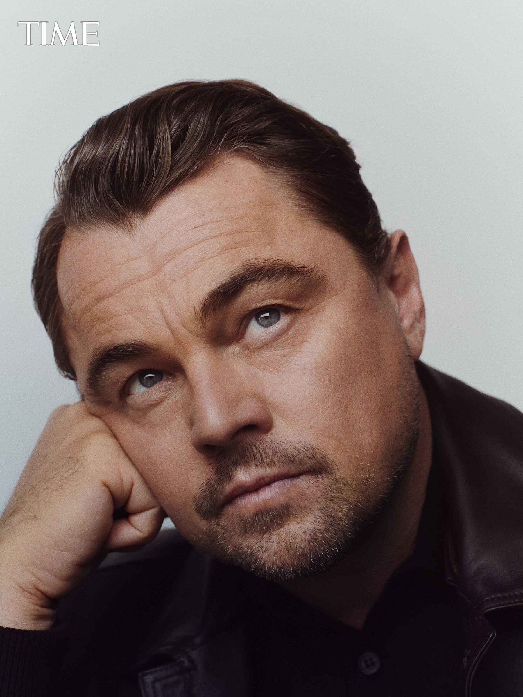 TIME Entertainer of the Year: Leonardo DiCaprio looking towards the camera, leaning his head on his hand.