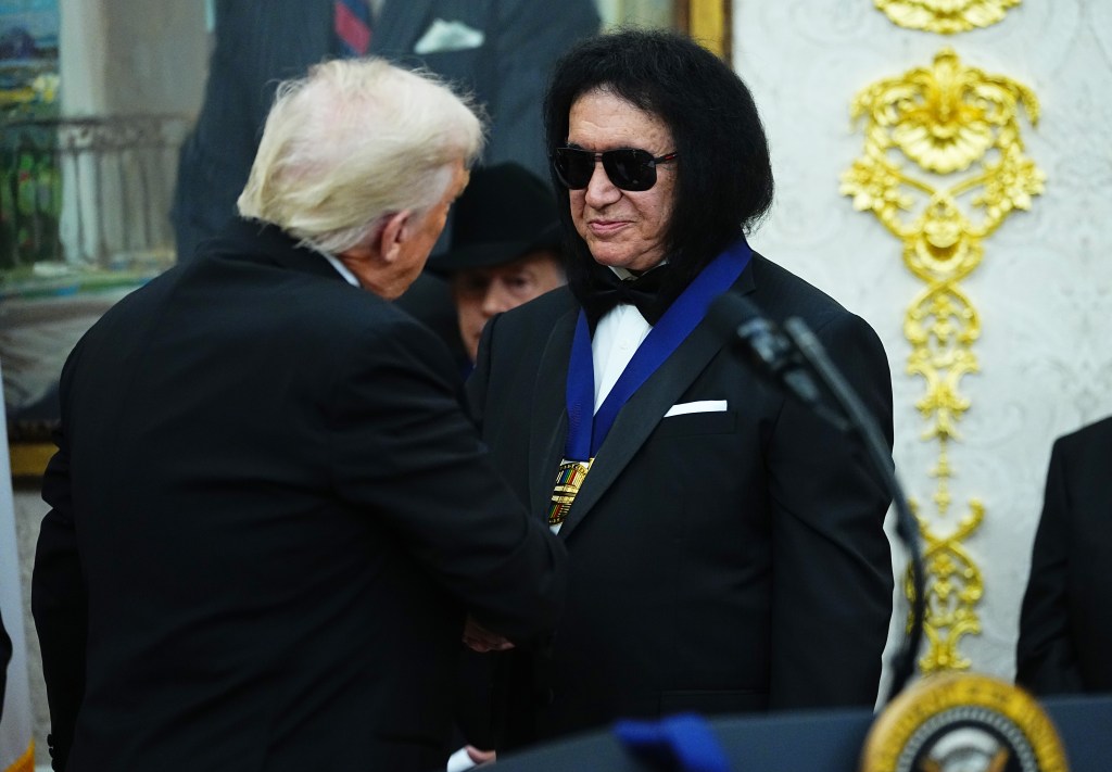President Trump presents a medal to Gene Simmons from KISS.