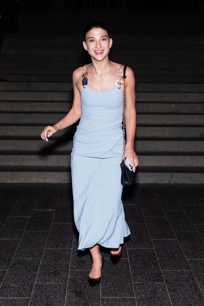 Phoebe Gates wearing a light blue dress with decorative straps and a small black bag, attending the Tiffany & Co. Blue Book 2025 launch.