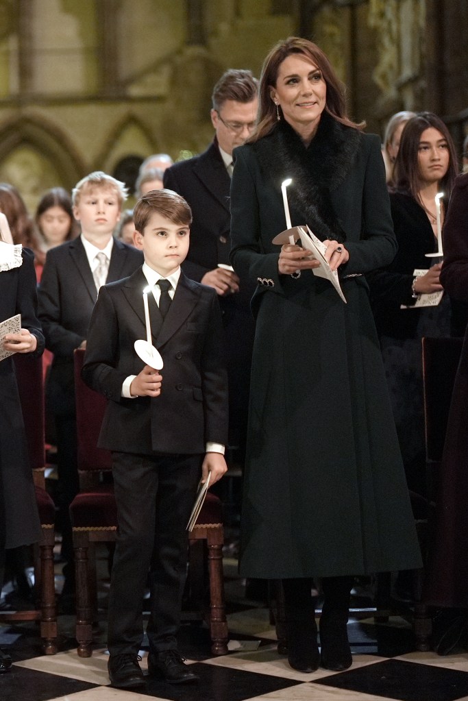Catherine, Princess of Wales, and Prince Louis holding lit candles at the Together At Christmas carol service.