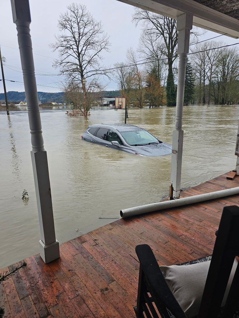 Flood water surrounds a car at a home in Duvall, Washington, on Dec. 11, 2025.
