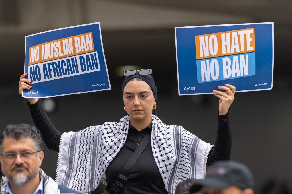 A woman holding signs that read