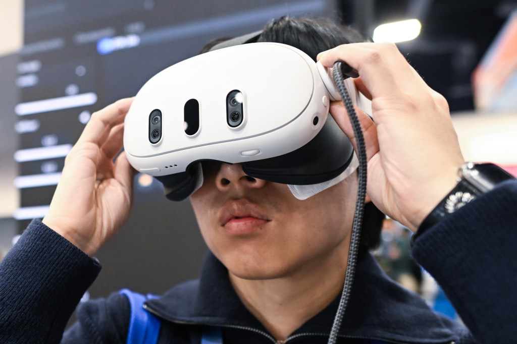 Person wearing a Meta Quest 3 mixed reality headset.