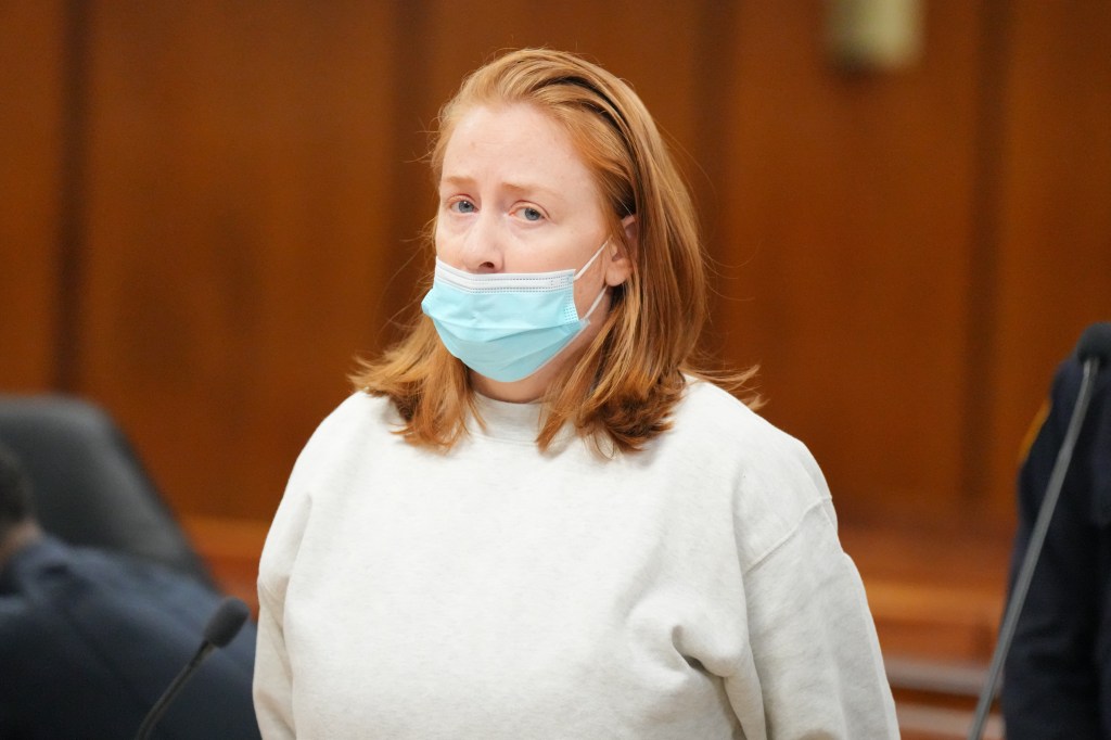 Kerri Aherne, the alleged attacker, in court wearing a light gray sweatshirt and blue face mask.