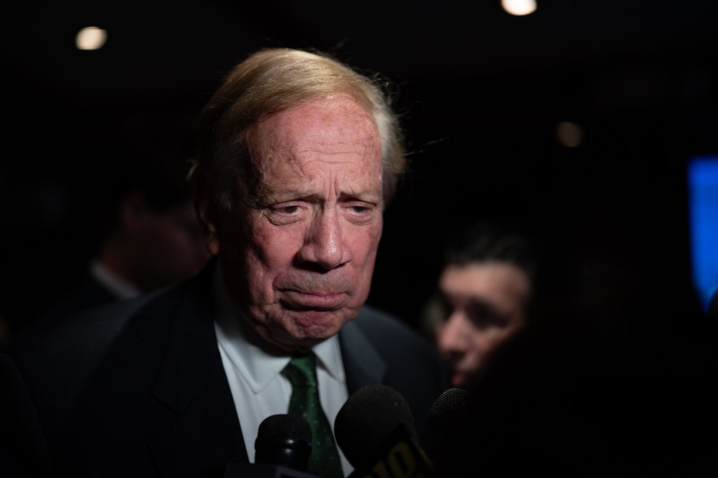 Former New York Gov. George Pataki speaking to microphones at an election-night watch party.