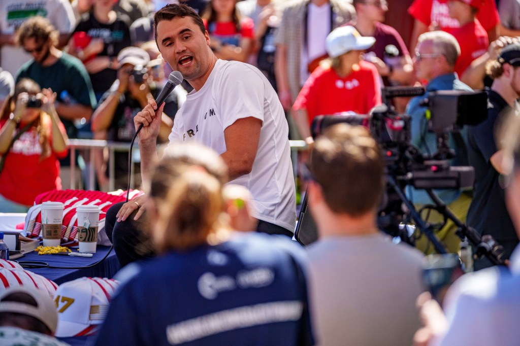 Charlie Kirk speaks into a microphone at an event in Orem, Utah.