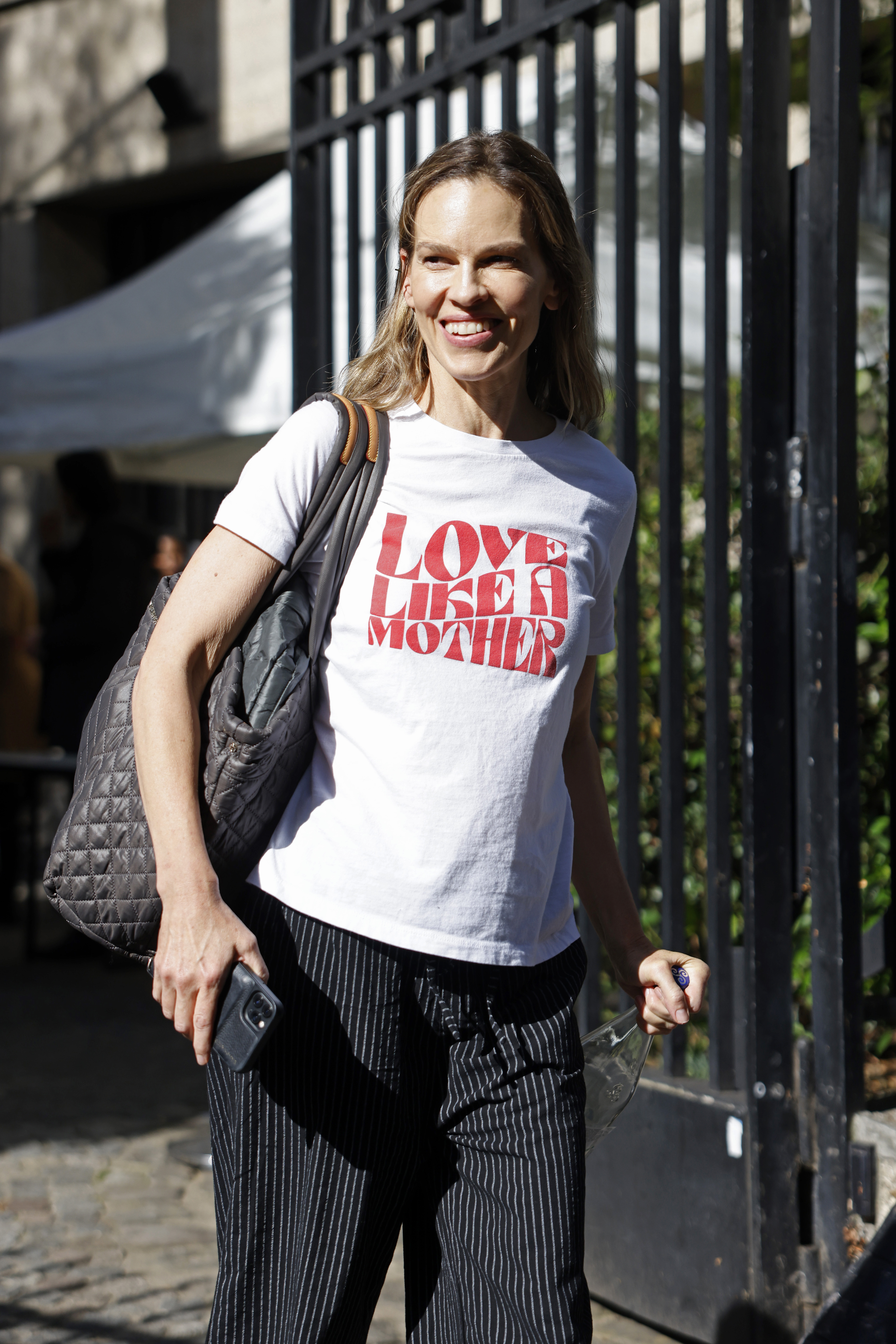 Hilary Swank in a white t-shirt that reads
