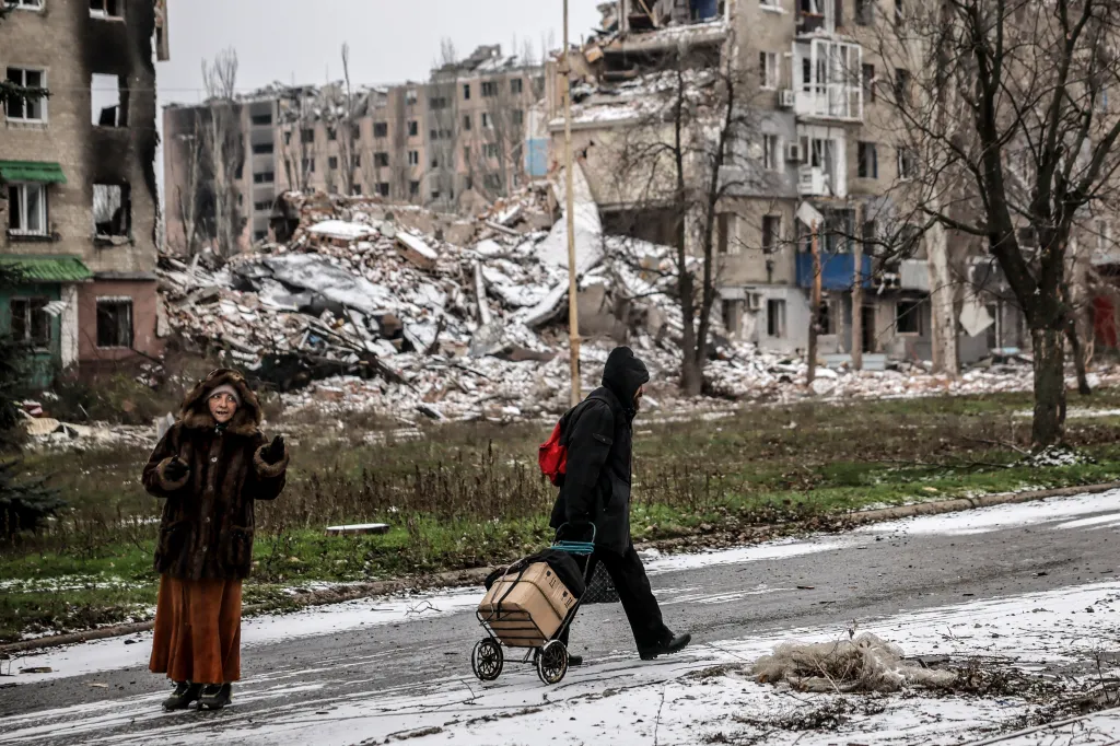 People walk along a street heavily damaged by a Russian attack in the Donetsk region of Ukraine on Dec. 17, 2025.