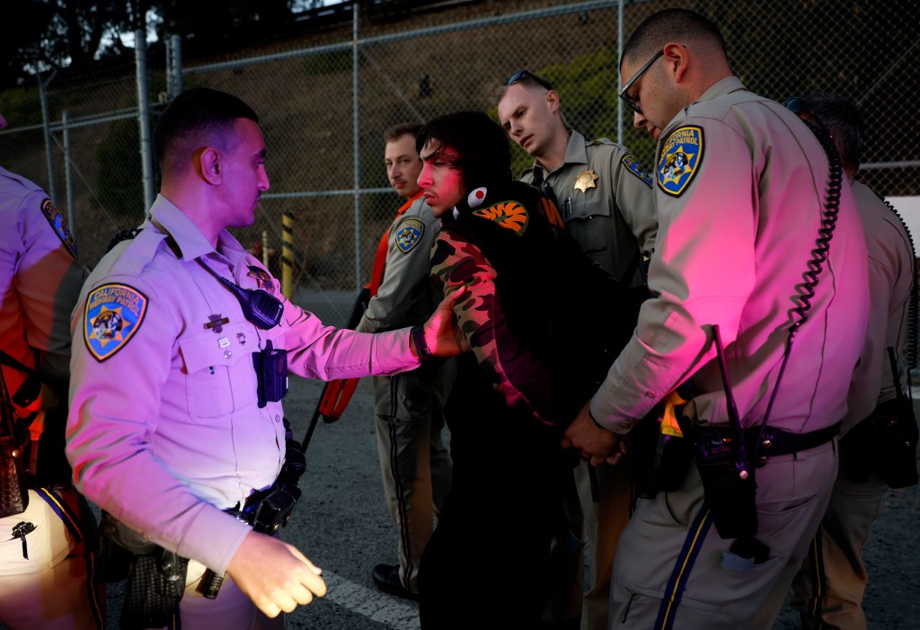 California Highway Patrol (CHP) officers take an armed robbery suspect into custody during a felony stop on October 16, 2025 in Richmond, California. 