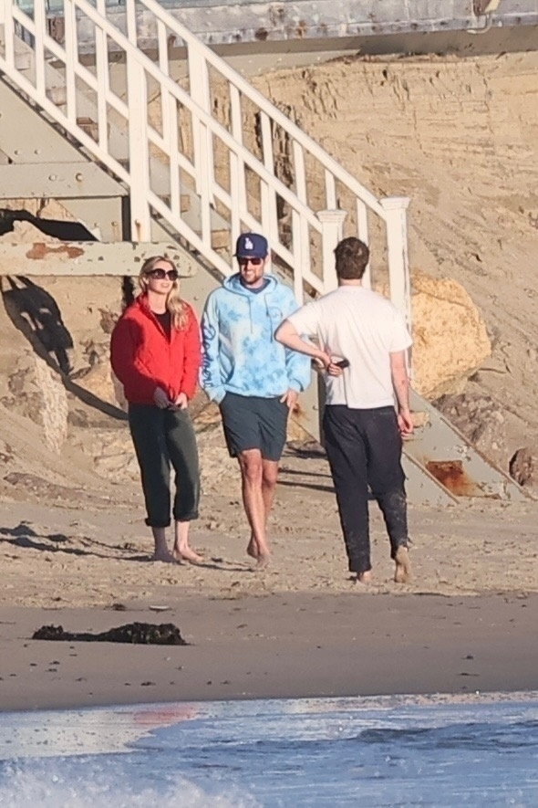Jake Reiner and Maria Gilfillan walk on Malibu Beach with Alex Silberberg.