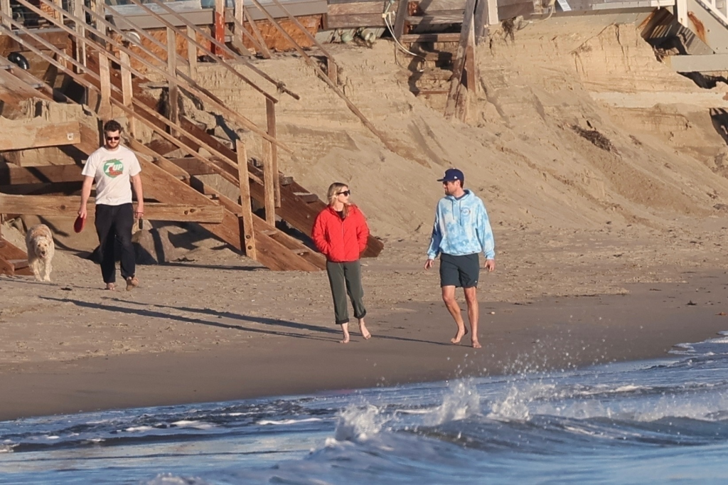 Jake Reiner, Maria Gilfillan, and Alex Silberberg walk on Malibu Beach.