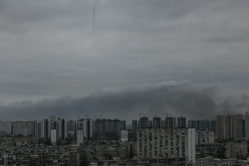 Smoke rises above residential buildings following Russian drones and missiles attack in Kyiv.