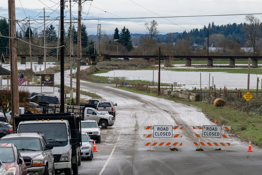 Road closed signs in Snohomish, Washington indicate flooded areas from heavy rain.