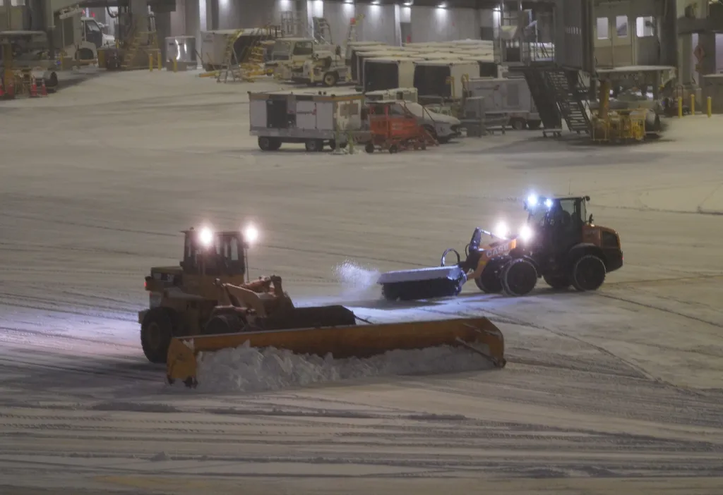 Snowplows clear the tarmac at LaGuardia Airport in New York during a snowstorm on Dec. 26, 2025.