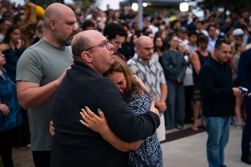 The parents of 10-year-old shooting victim, Matilda Poltavchenko, embraces at a memorial at Bondi Pavilion at Bondi Beach on December 15, 2025 in Sydney, Australia.