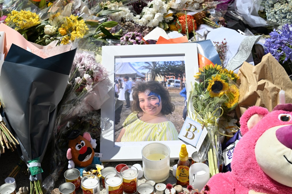 A portrait of 10-year-old Matilda, victim of the Bondi Beach shooting, sits on a flower memorial beside Bondi Pavilion on December 17, 2025 in Sydney.