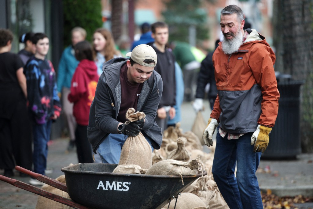 Volunteers fill sandbags for businesses along the Skagit River in Mount Vernon, Washington, on Dec. 12, 2025.