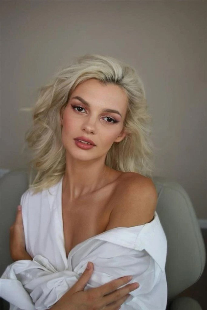 Photo of Iryna Zarutska, a young woman with blonde hair and a white shirt.Iryna