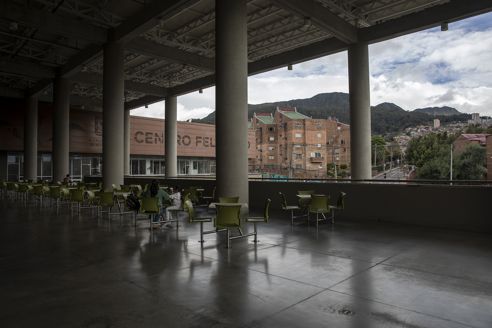 a view of Bogotá, Colombia from an outdoor seating area attached to a large multi-use building