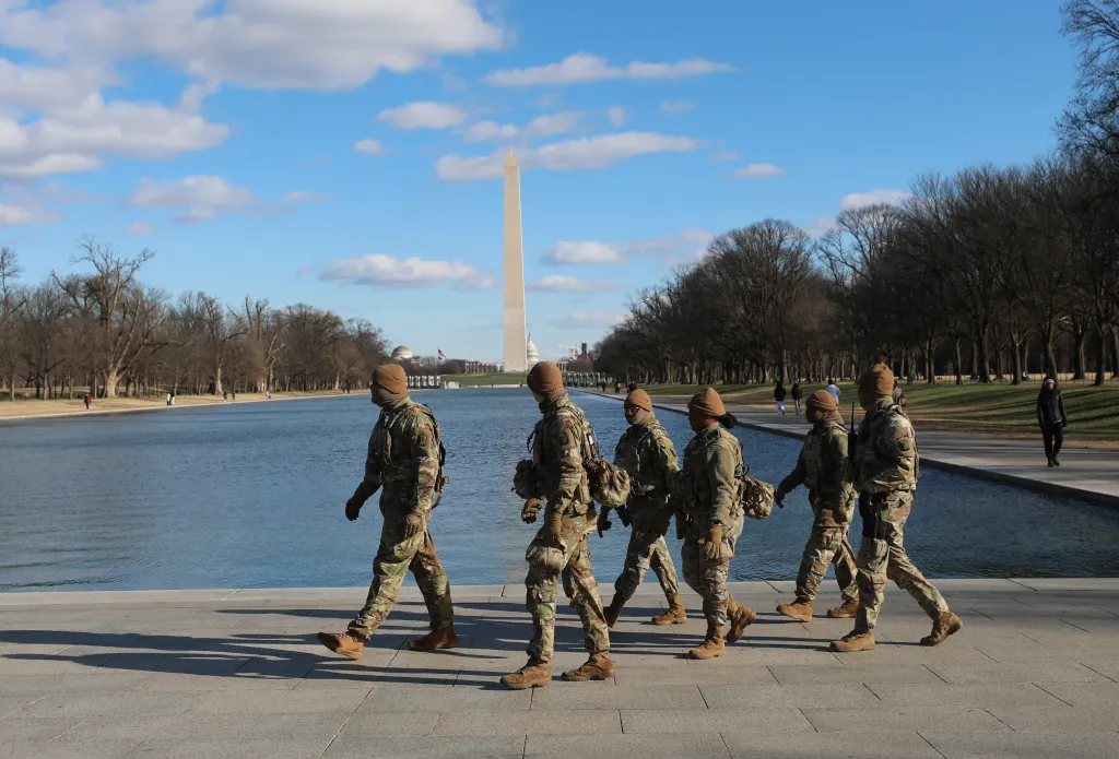 National Guard patrol in the Lincoln Memorial in Washington, with the Washington Monument in the background.