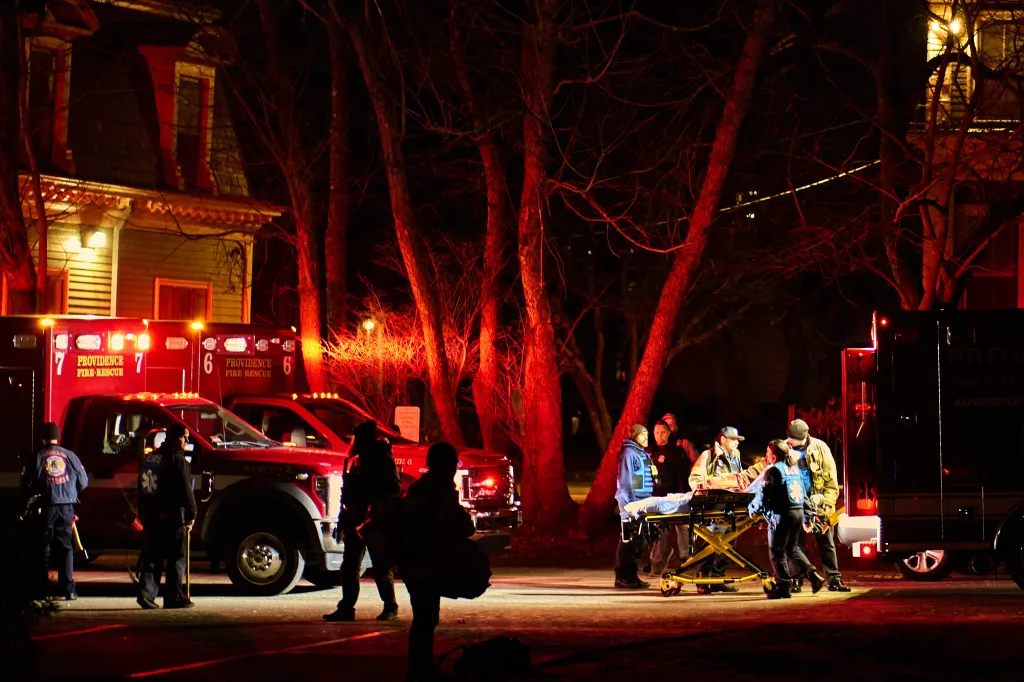 First responders with the Providence Fire Department maneuver an empty stretcher near the Barus & Holley building, home to the engineering and physics departments and the site of a mass shooting, at Brown University campus in Providence, Rhode Island, on December 13, 2025.